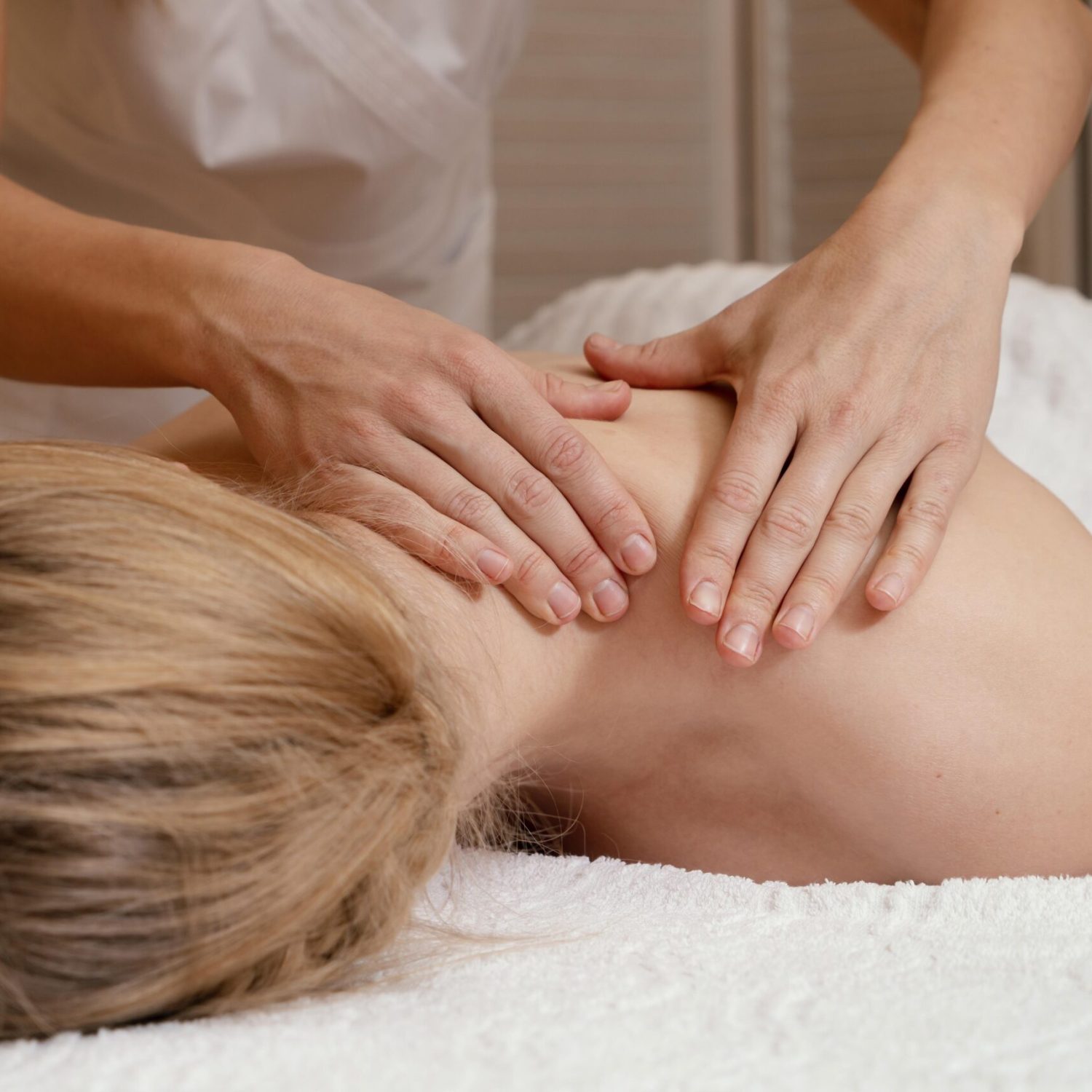 close-up-hands-massaging-woman-s-back